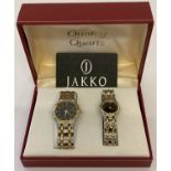 A boxed ladies and gents matching quartz wristwatch set.