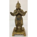 A gilt bronze Oriental figure, on a pedestal base.