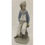 A Lladro ceramic retired figurine #4810 Sailor "Boy with Yacht", modelled by Salvador Furio.