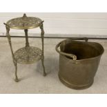 A two tier pierced work plant/saucepan stand with floral and cherub decoration.