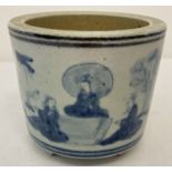A blue and white hand painted pot, raised on 3 small stepped feet.