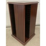 A modern mahogany finish revolving CD rack.