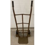 A vintage metal sack barrow with rubber tyres and rubber hand grips.