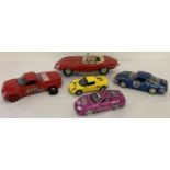 5 assorted scale diecast racing style model cars.