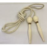 A vintage wooden handled "Flexten" ball bearing skipping rope.