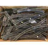 A box of assorted OO gauge model railway track and points.