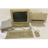 A vintage Apple Macintosh LC home computer with Color Stylewriter 2400, printer, keyboard and mouse.