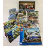 A collection of assorted Lego play pieces and instruction manuals.