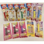 A collection of 11 assorted Pez sweet dispensers in blister packs and 1 other.