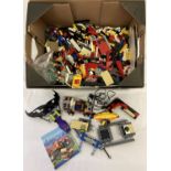 A box of assorted loose Lego pieces and part vehicles.