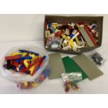 A quantity of vintage Lego pieces and accessories, to include: windows, flowers, doors and wheels.