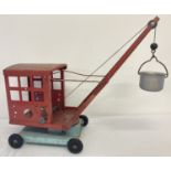 A vintage red and blue 1950's No. 2 tinplate crane with bucket and swivel base by Tri-Ang.