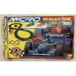 A boxed Micro Scalextric, World Championship Edition, with Benneton and Ferrari racings cars.