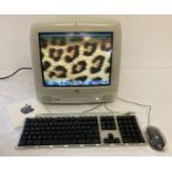 An Apple iMac G3 computer complete with keyboard, mouse and start up disks.