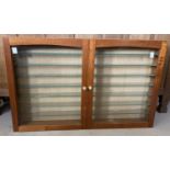 A large glass fronted, wooden wall hanging model display cabinet.