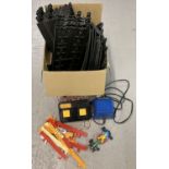 A box of Scalextric track, railings, controller, power unit and a Benetton racing car.