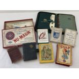 A collection of vintage playing cards, toys and card games.