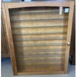 A large glass fronted wooden wall hanging model display cabinet.