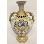 A ceramic two handled urn style Tuscan Ware vase with nesting bird, ribbon and floral decoration.