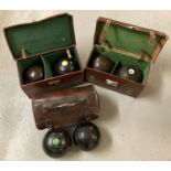 3 pairs of vintage lawn bowls complete with leather cases.