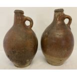 2 antique Bellarmine stone ware jugs of bulbous form with circular detail to top rims.