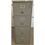 A vintage metal 4 drawer lockable filing cabinet, complete with key.