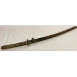 A 1936 Japanese Samurai sword and scabbard with a Ray skin handle, bronze mounts and a signed blade.