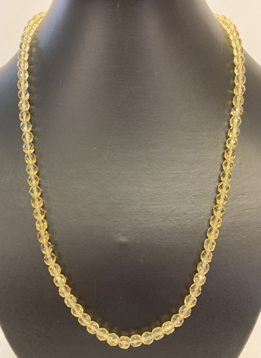 A 21" faceted yellow glass beaded necklace, possibly citrine, with gold tone T bar clasp.