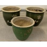 A pair of green glaze ceramic garden pots with floral design.