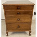 A solid dark wood 4 drawer small chest of drawers with bun handles and cabriole legs.