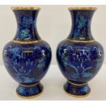 A pair of blue oriental cloisonné vases of bulbous form, with double dragon detail to both.