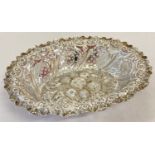 A Victorian highly decorative silver bon bon dish with pierced work, fruit and floral detail.
