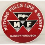 A circular shaped painted cast metal Massey-Ferguson Tractors wall plaque.