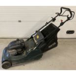 A Hayter Harriet 56 self propelled large cut lawnmower with grass collection basket.