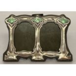 A small Art Nouveau style freestanding double picture frame with enamelled detail.