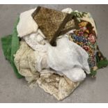 A large quantity of vintage table cloths and accessories to include chenille, lace and linen.