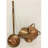 An antique copper swing handled coal scuttle with aged rivetted repair to base.