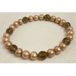 A pearl and smoked quartz expanding bracelet.