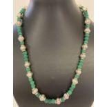 A 20" costume jewellery necklace made from dyed green fossil and white metal beads.