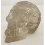 A small carved rock crystal figurine in the shape of a skull.