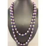 A 47" beaded necklace made from alternating freshwater pearls and amethyst beads.