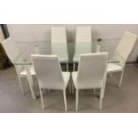 A modern glass top and white painted metal dinning table and 6 chairs.