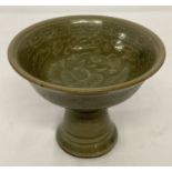 A small Chinese ceramic celadon glazed stem cup with phoenix detail to inner bowl.