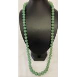 A 32" Chinese jade beaded necklace, knotted between each bead.