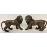 A pair of brass bronzed effect roaring lion mantel figures.