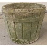 A vintage concrete half barrel design garden planter with drainage hole to base.