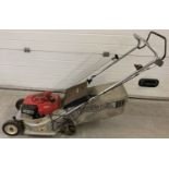 A Honda HR173 petrol lawnmower with grass collection basket.