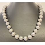A 16" string of larger sized silver/grey lustre freshwater pearls, with magnetic clasp.