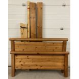 A modern design double pine bed frame with carved detail to head and base board.