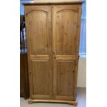 A modern Lavenham double pine wardrobe with interior shelf and hanging rail.